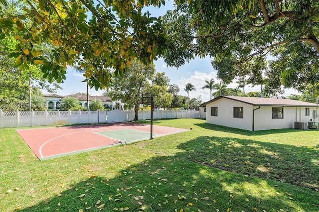 view of basketball court with a lawn