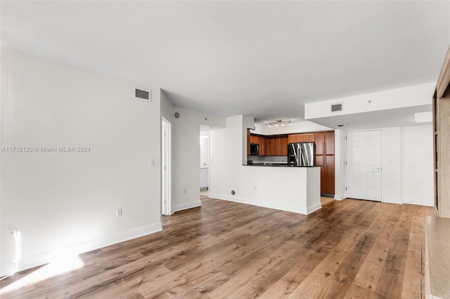 unfurnished living room with light hardwood / wood-style flooring