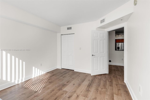 unfurnished room with light wood-type flooring