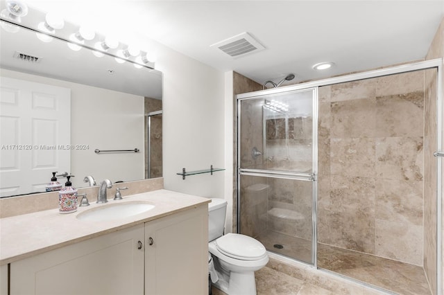 bathroom with vanity, toilet, and an enclosed shower