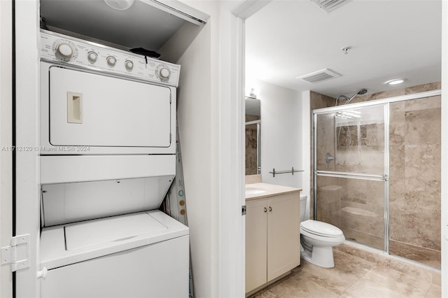 laundry area featuring stacked washer and clothes dryer