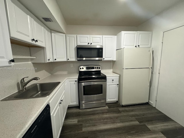 kitchen with dark hardwood / wood-style flooring, white cabinetry, sink, and stainless steel appliances