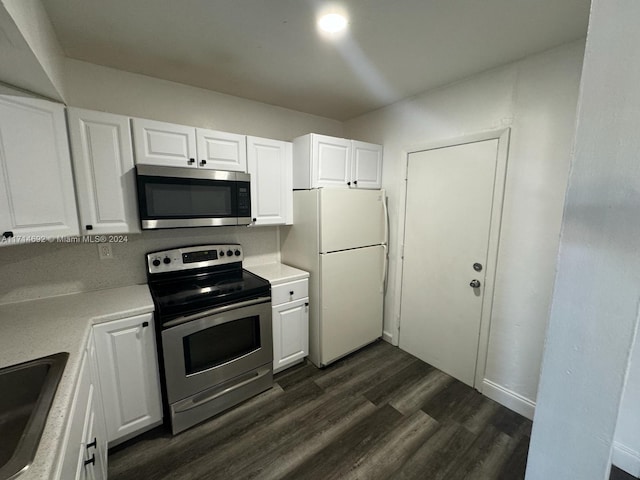 kitchen featuring white cabinets, stainless steel appliances, and dark wood-type flooring