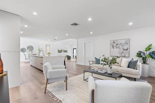 living room with light hardwood / wood-style flooring