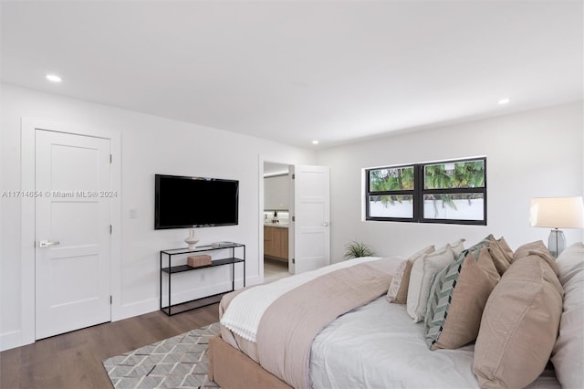 bedroom featuring hardwood / wood-style flooring and ensuite bath