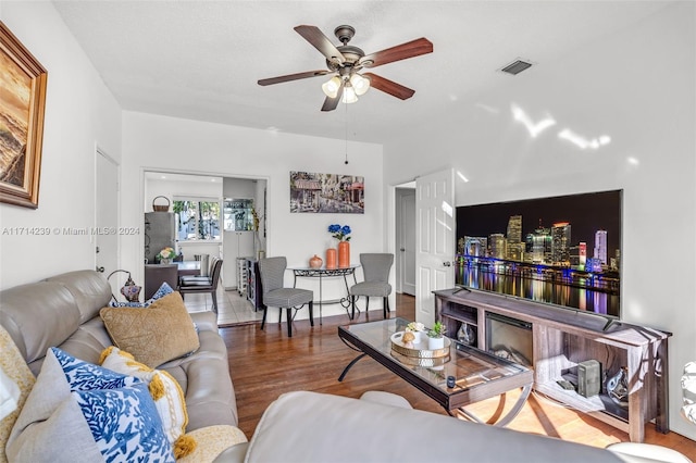 living room featuring ceiling fan and hardwood / wood-style flooring