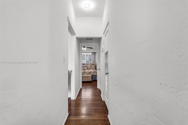 corridor featuring dark hardwood / wood-style floors