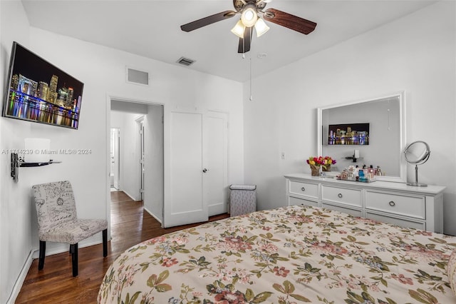 bedroom with ceiling fan and dark hardwood / wood-style flooring