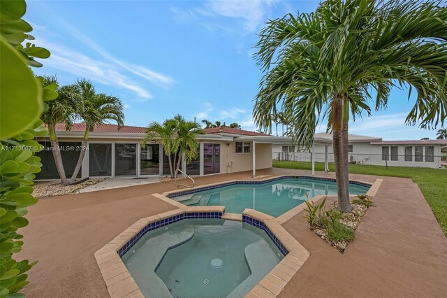 view of pool with a patio area and an in ground hot tub