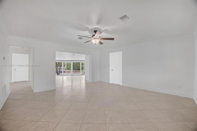 empty room with light tile patterned floors and ceiling fan