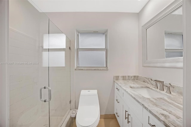 bathroom featuring vanity, toilet, and walk in shower