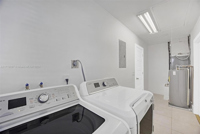 clothes washing area featuring washer and dryer, light tile patterned floors, and electric panel