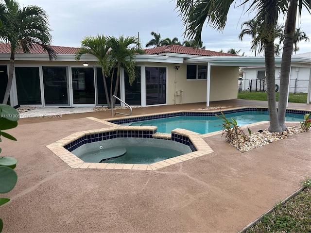 view of swimming pool with an in ground hot tub and a patio area