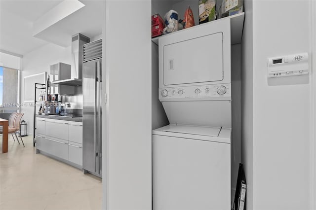 laundry room with stacked washer and dryer