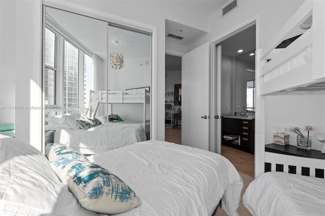 bedroom with tile patterned flooring and a closet