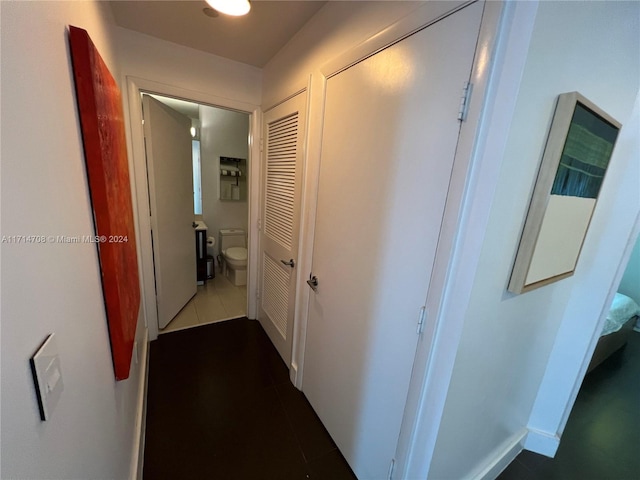 hall with dark tile patterned flooring