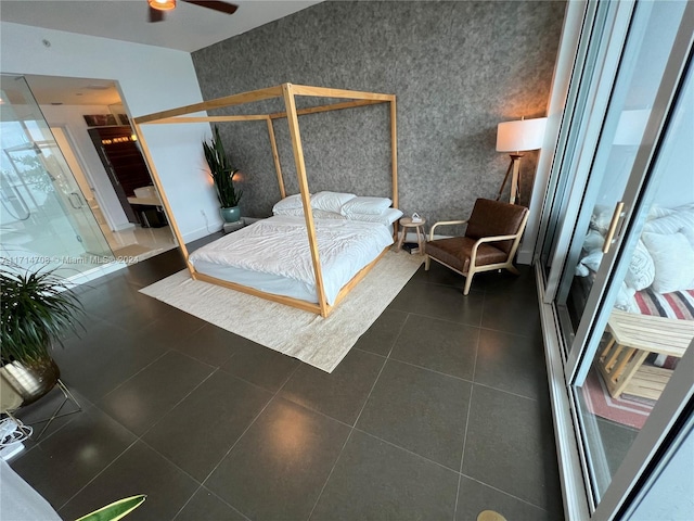 bedroom with dark tile patterned floors and ceiling fan