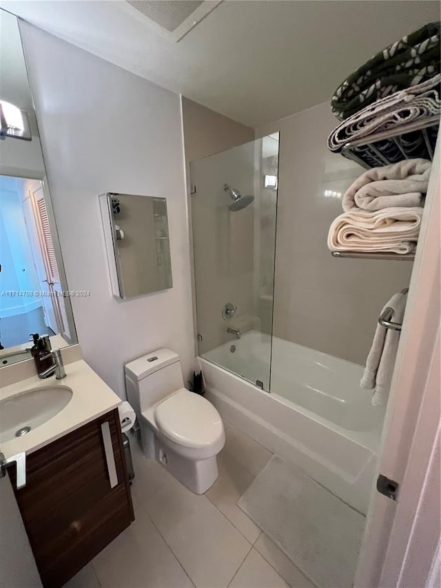 full bathroom featuring tile patterned floors, shower / bath combination with glass door, vanity, and toilet