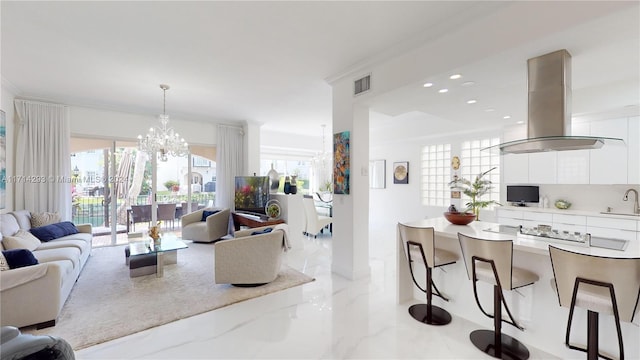 living room featuring a wealth of natural light, sink, ornamental molding, and an inviting chandelier