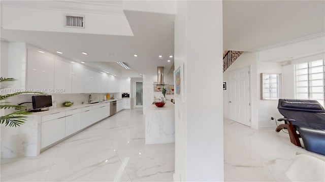 kitchen with sink, white cabinets, stainless steel dishwasher, and ornamental molding