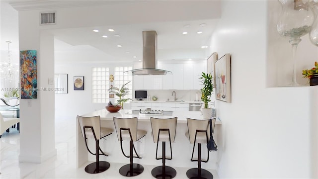 kitchen with white cabinetry, sink, island exhaust hood, decorative backsplash, and black electric stovetop