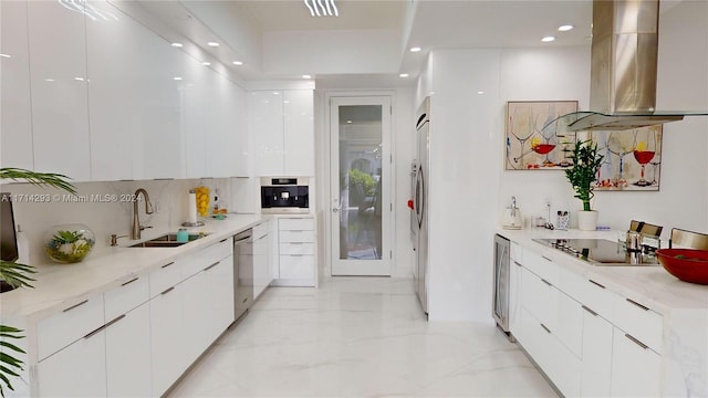 kitchen with sink, white cabinetry, island exhaust hood, and stainless steel appliances