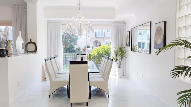 dining space featuring a wealth of natural light, an inviting chandelier, and ornamental molding