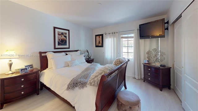 bedroom featuring light wood-type flooring and a closet