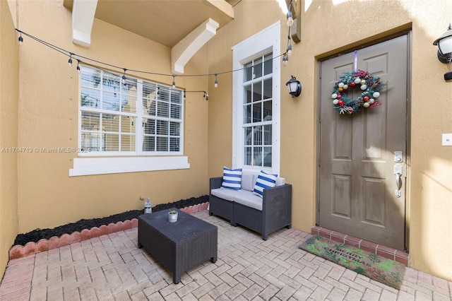 entrance to property featuring a patio area