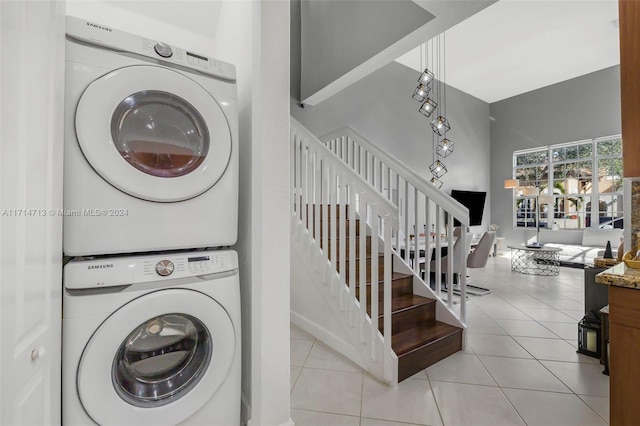 washroom with light tile patterned floors and stacked washer and clothes dryer