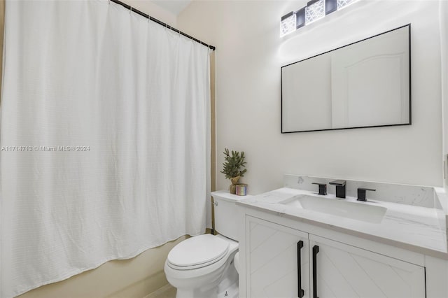 full bathroom with shower / tub combo, vanity, and toilet