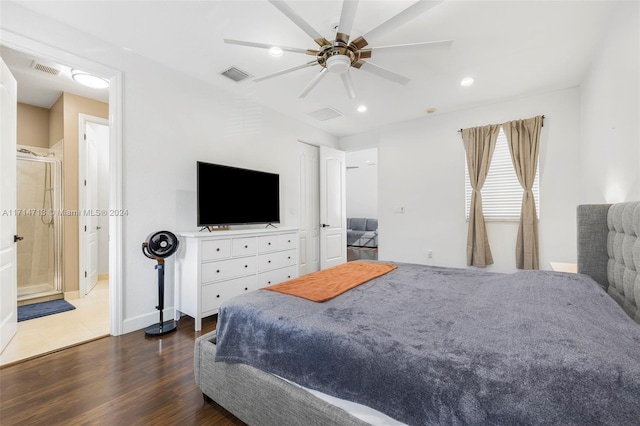 bedroom with ceiling fan, dark hardwood / wood-style flooring, and ensuite bath