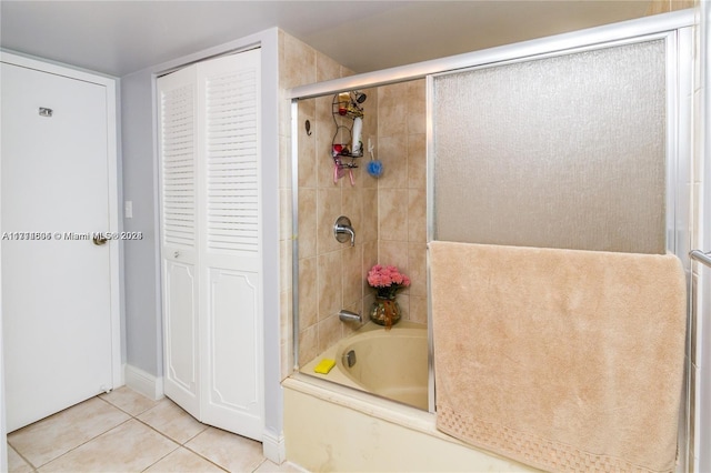 bathroom featuring tile patterned floors and bath / shower combo with glass door