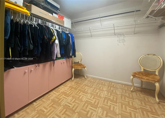 spacious closet with light parquet flooring