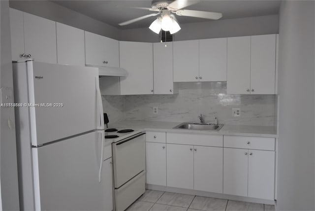 kitchen with white appliances, backsplash, sink, ceiling fan, and white cabinetry