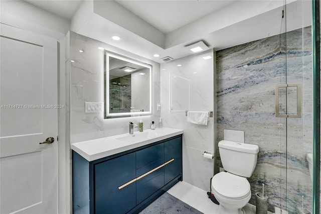 bathroom featuring a shower, vanity, tile walls, and toilet