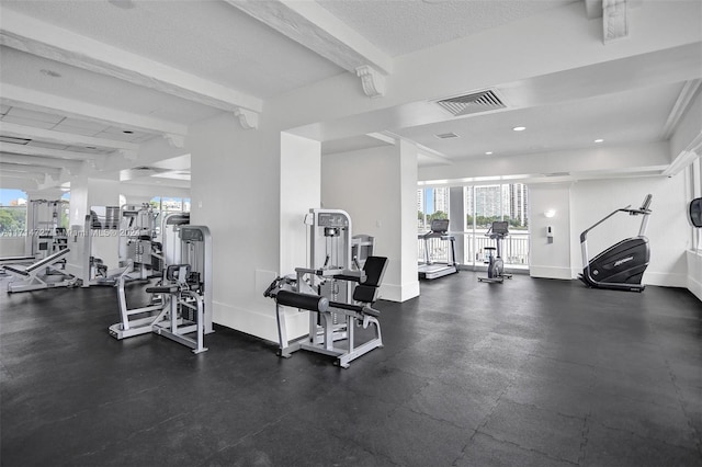 workout area with a healthy amount of sunlight and a textured ceiling