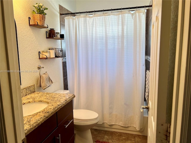 full bathroom with tile patterned floors, shower / tub combo with curtain, vanity, and toilet