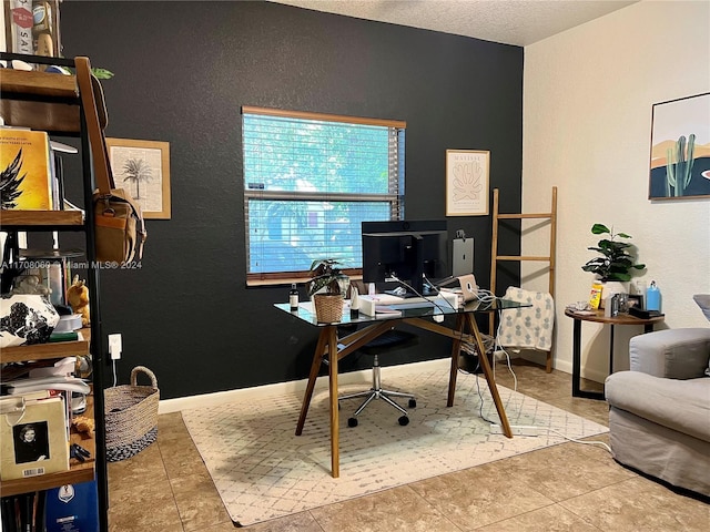 tiled home office with a textured ceiling