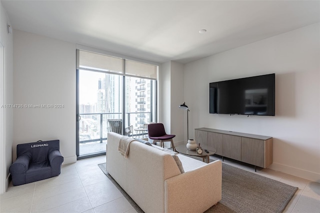 tiled living room featuring a wall of windows