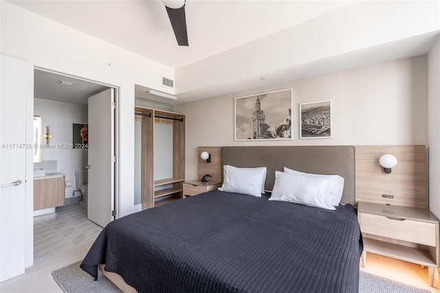 bedroom featuring ensuite bath and ceiling fan