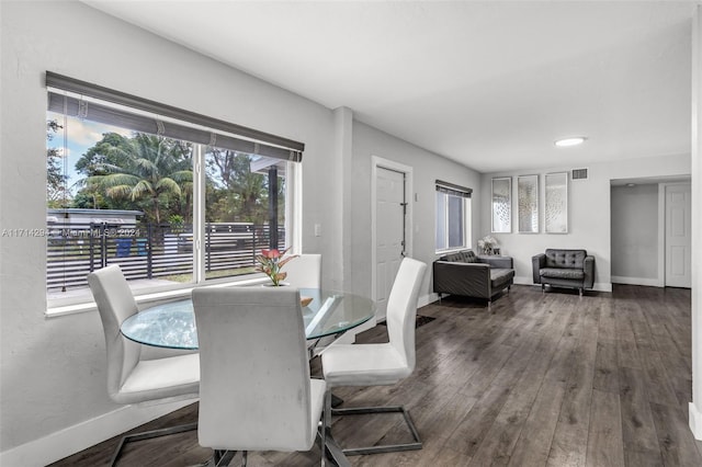 dining area with dark hardwood / wood-style flooring