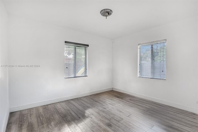 empty room with hardwood / wood-style flooring