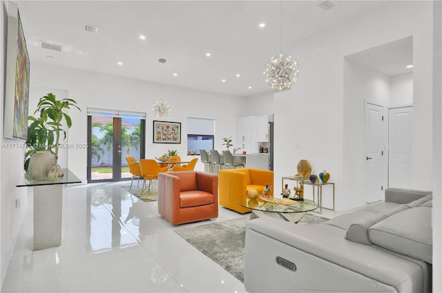 living room with an inviting chandelier and french doors