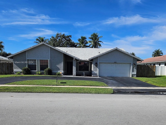 ranch-style house with a front yard and a garage