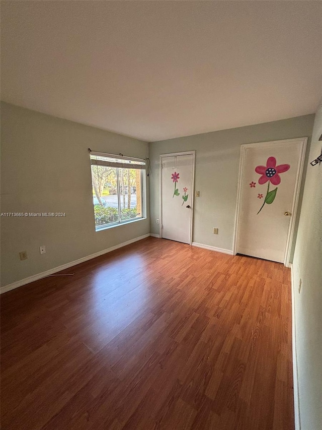 empty room with hardwood / wood-style flooring