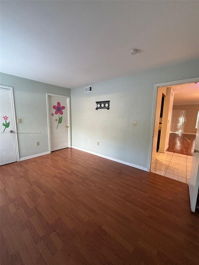 spare room with wood-type flooring