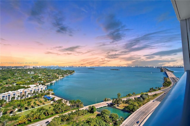 aerial view at dusk with a water view