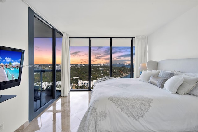 bedroom featuring access to exterior and a wall of windows