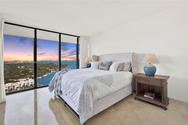 bedroom featuring a wall of windows and access to outside